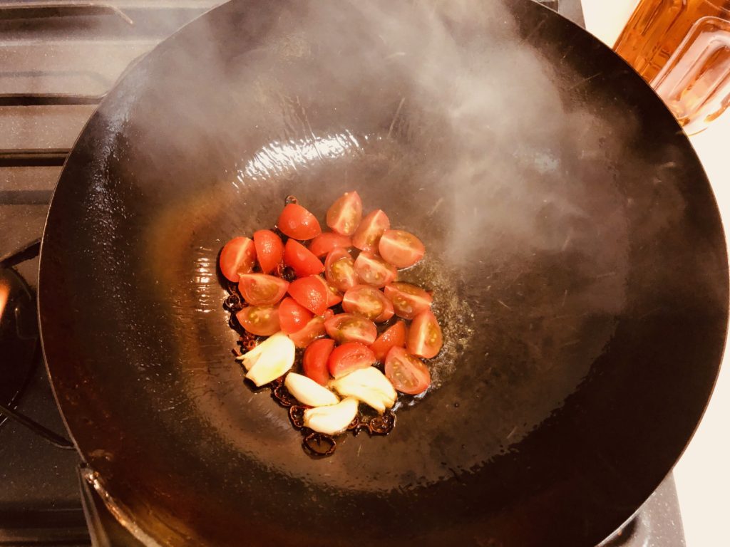Stir in tomato and garlic